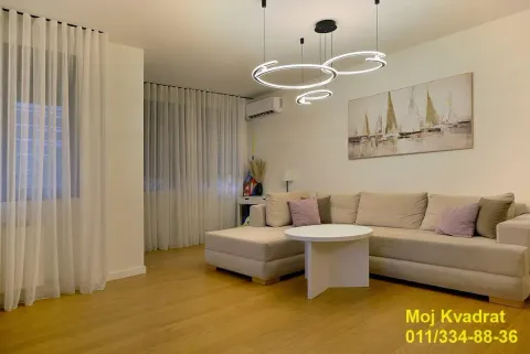Living room with a sectional sofa, coffee table, and modern chandelier. - image 3