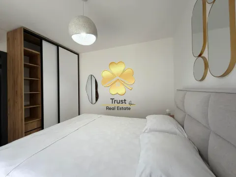 Modern bedroom with a double bed, wardrobe, and decorative mirrors. - image 10