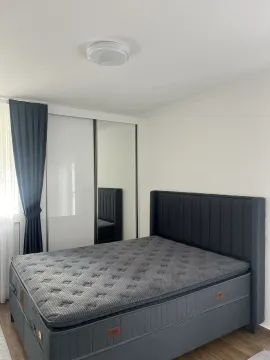 Bright bedroom with a large bed and a wardrobe. - image 6