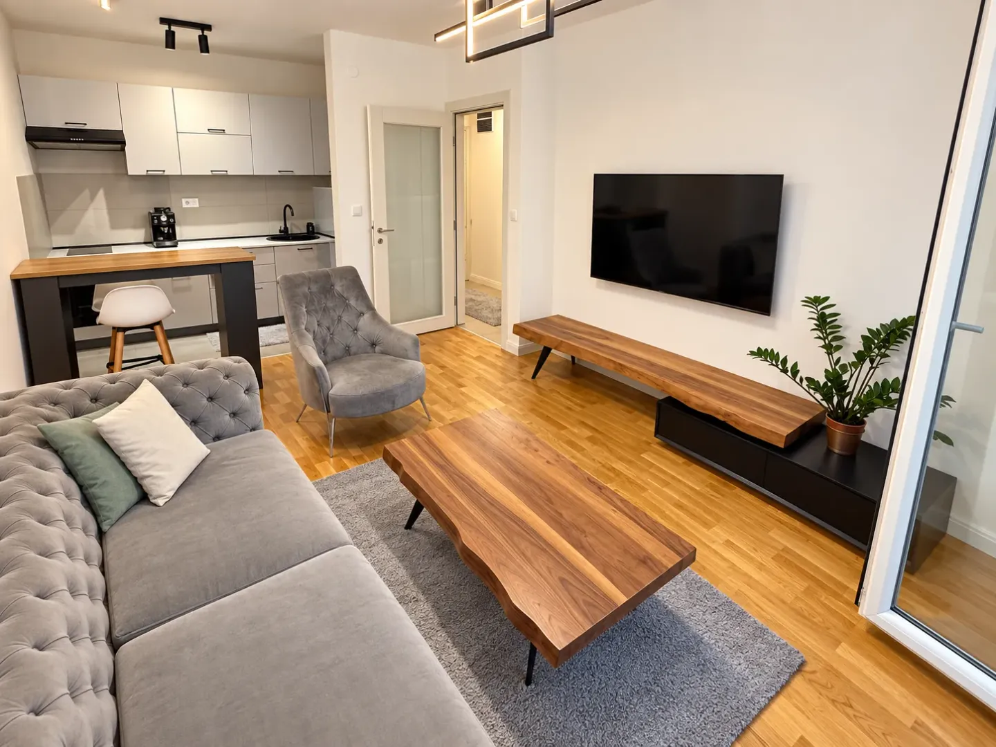Modern living room connected to the dining area and kitchen.