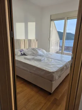 Pogled iz hodnika na spavaću sobu sa krevetom i izlazom na terasu sa pogledom na more. - image 2