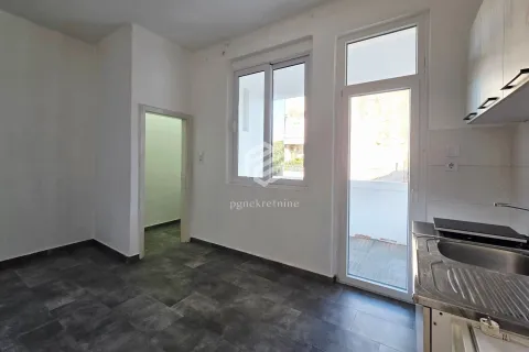 Small kitchen with access to the terrace and dark floor tiles. - image 10