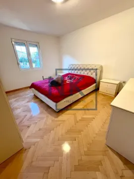 Bedroom with a double bed, nightstands, and parquet flooring. - image 7
