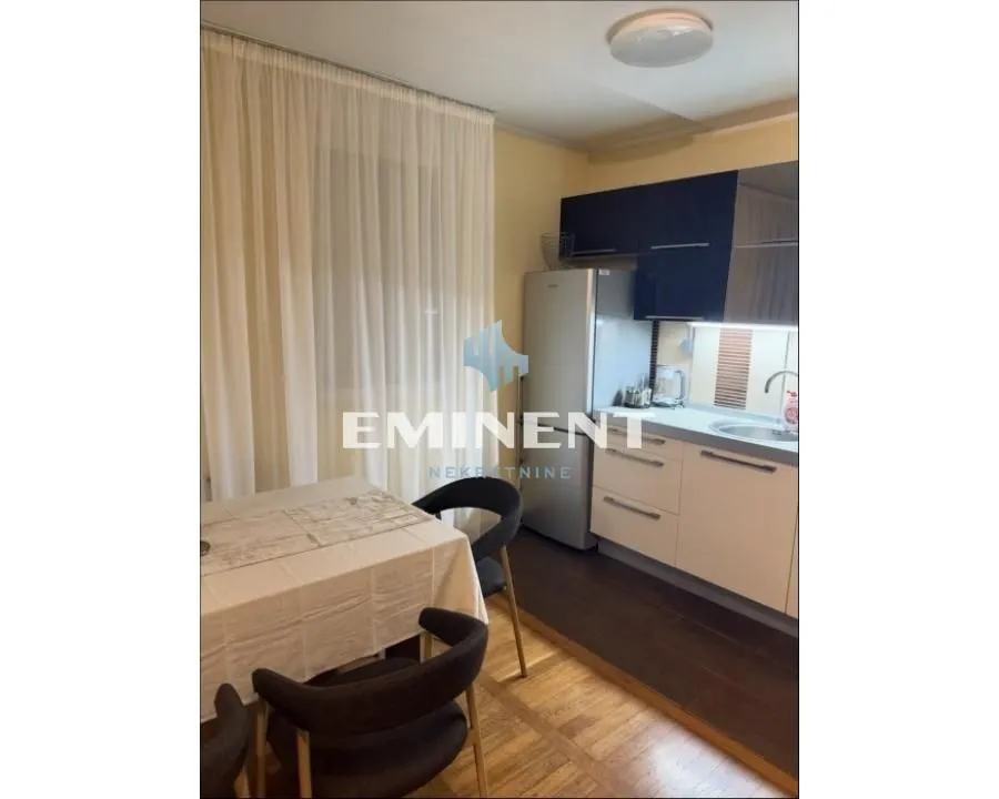 Smaller kitchen with a dining table and chairs near the window.