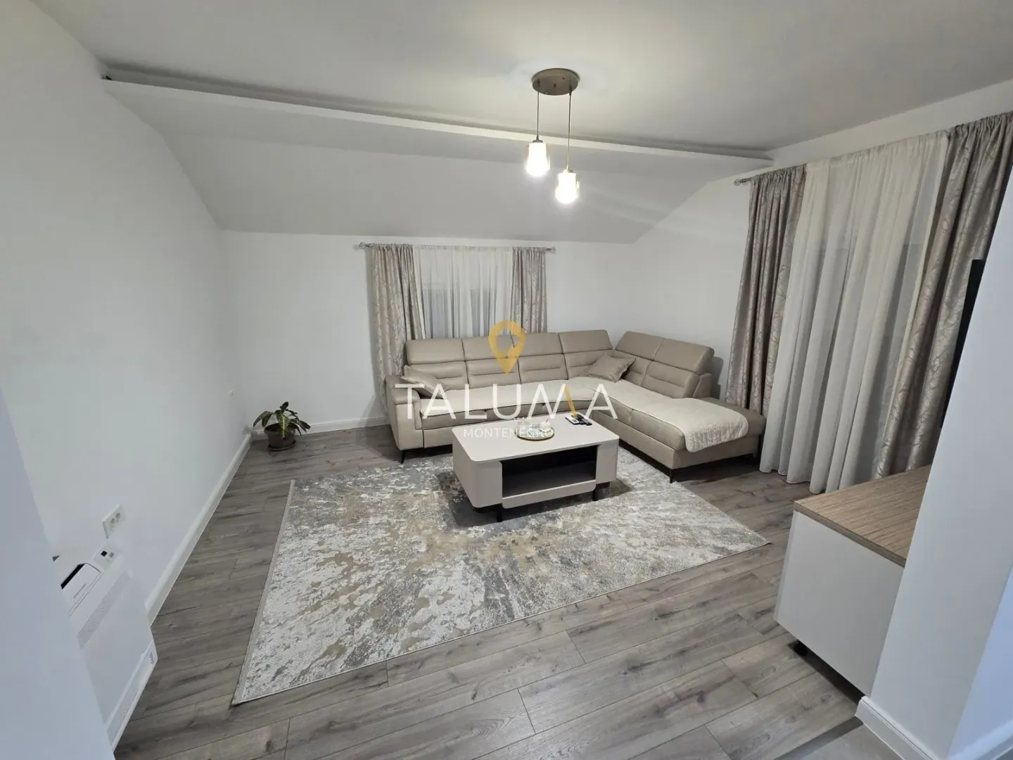 Living room with a sectional sofa, coffee table, and a rug.