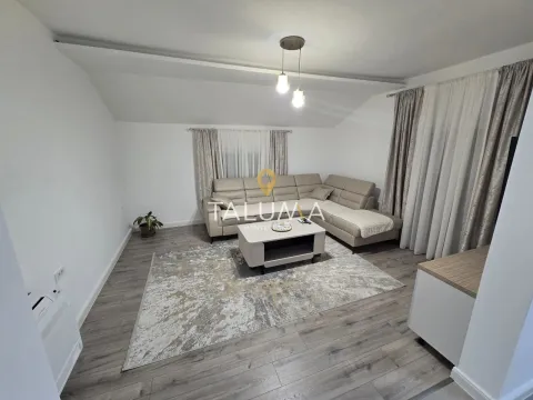 Living room with a sectional sofa, coffee table, and a rug. - image 3