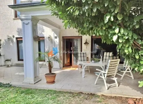 Covered terrace with outdoor seating in front of the house. - image 2