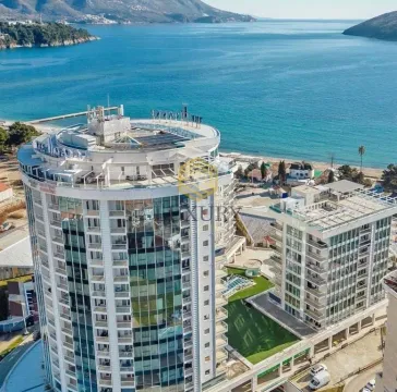 Aerial view of a modern hotel and residential complex overlooking the sea. - image 2