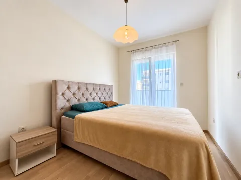 Furnished bedroom with a double bed and a nightstand. - image 3