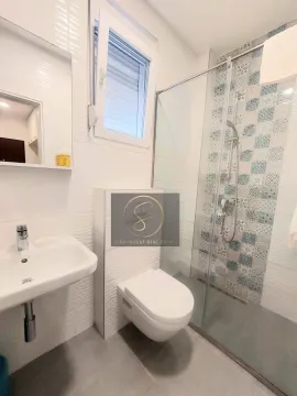 Modernly equipped bathroom with a walk-in shower. - image 5