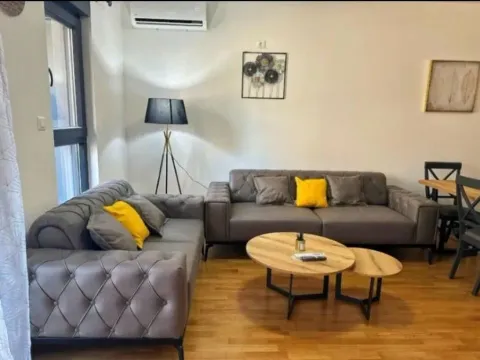 Living room with sofa set, coffee tables, and dining table in the background. - image 2