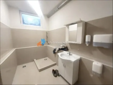 Bathroom with a shower enclosure, washbasin, and mirror. - image 15