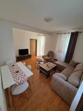 Living room with dining area, sofa set, and TV. - image 2