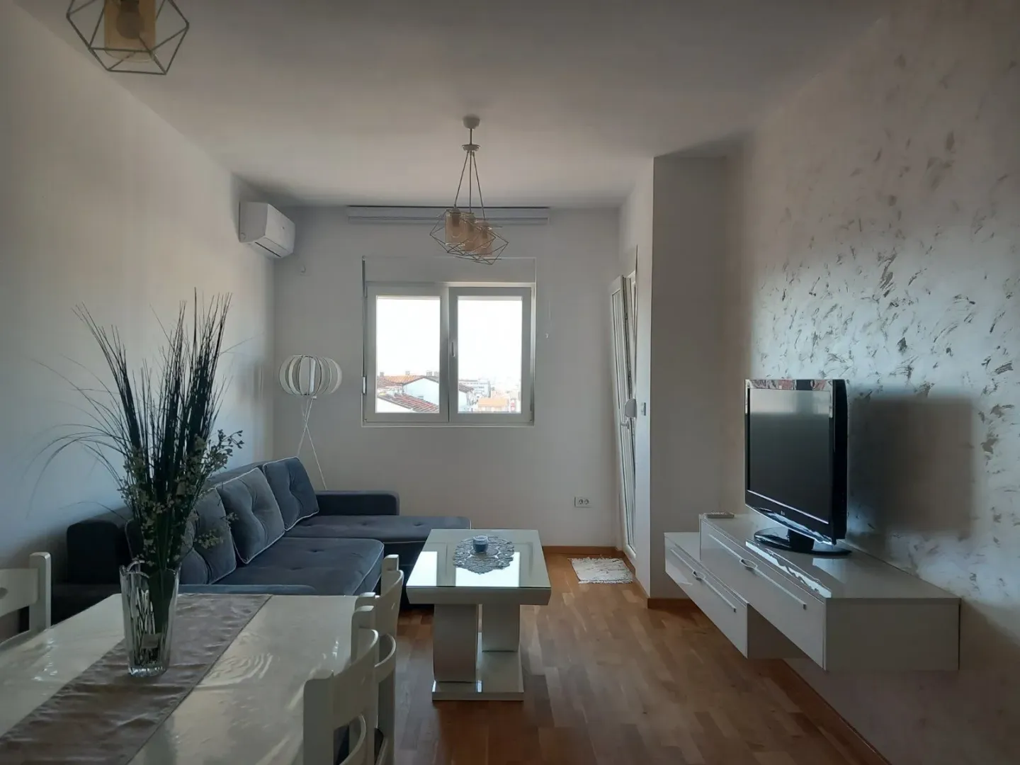 Bright living room with a sectional sofa and a TV.