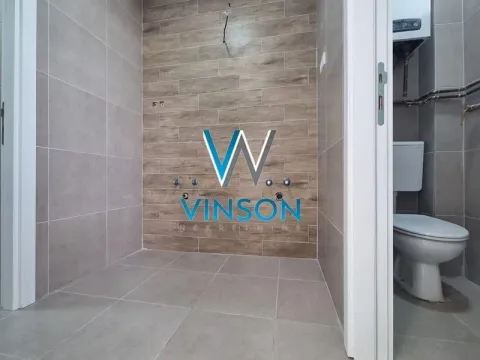 View of the tiled bathroom during furnishing. - image 5