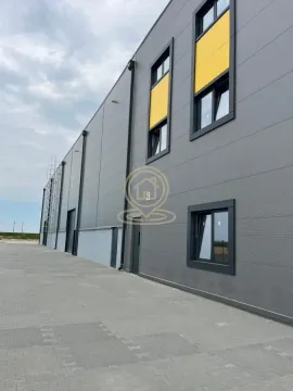 Exterior view of a modern commercial or industrial building with a paved yard. - image 6