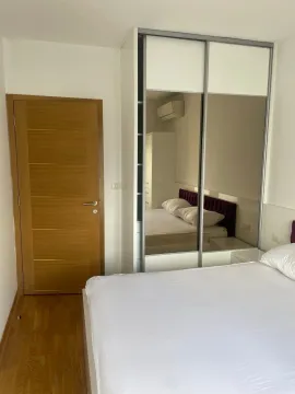 Furnished bedroom with a large mirrored wardrobe and a double bed. - image 7