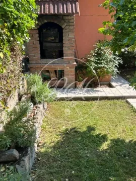 Green yard with a brick barbecue and a walkway. - image 19