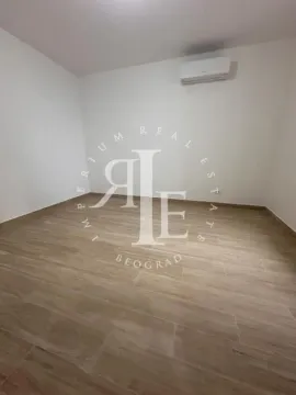 Empty room with light walls, wood flooring, and an air conditioning unit. - image 8