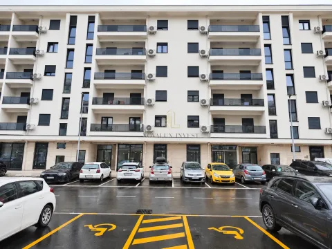 Exterior view of the residential building with a parking lot in front. - image 12