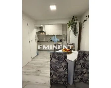 Dining area with a table and chairs, looking towards the kitchen in the background. - image 5