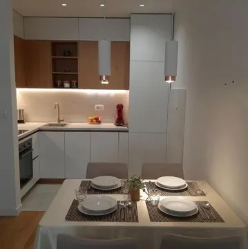 Modern kitchen with a dining table and built-in units. - image 4