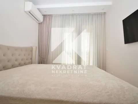 Bedroom with a double bed, air conditioning, and a wall-mounted TV. - image 6