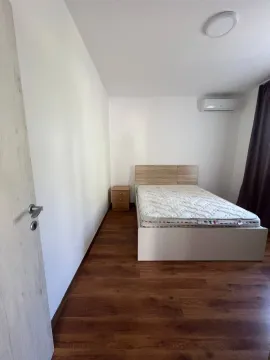Bedroom with a double bed, nightstand, and air conditioner. - image 8