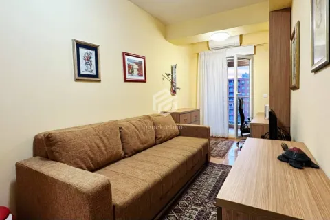 Living room with a brown sofa, wooden furniture, and access to the balcony. - image 17