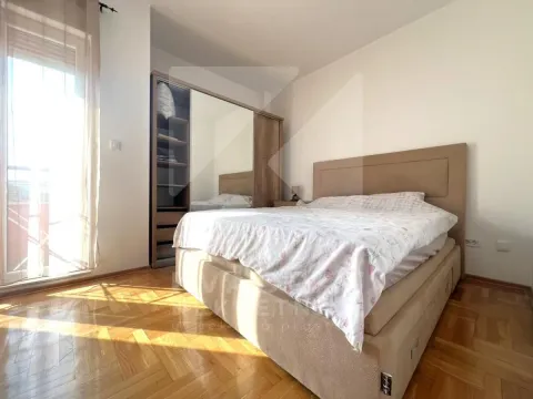 Bedroom with a double bed, mirrored wardrobe, and parquet flooring. - image 7