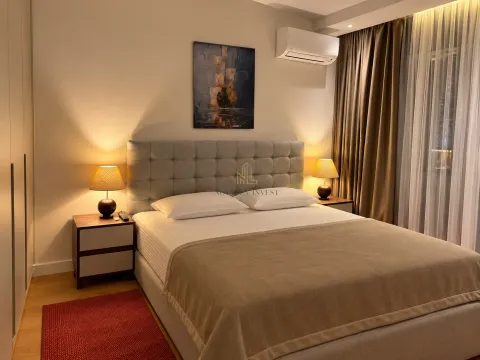 Modern bedroom with a double bed, bedside tables, and lighting. - image 8