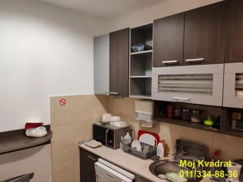View of a smaller kitchen with wall cabinets and a countertop. - image 10