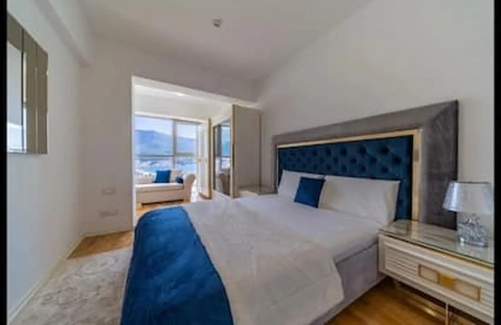 Spacious bedroom with a double bed and a sea view.