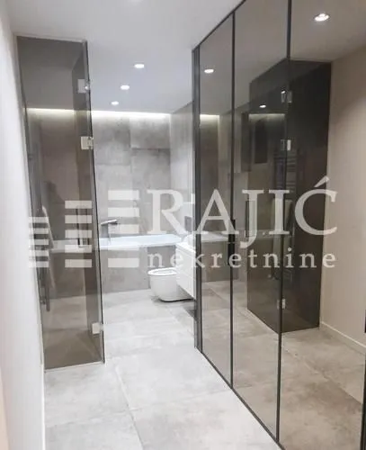 Modern bathroom with walk-in shower and bathtub.