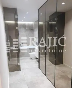 Modern bathroom with walk-in shower and bathtub. - image 6