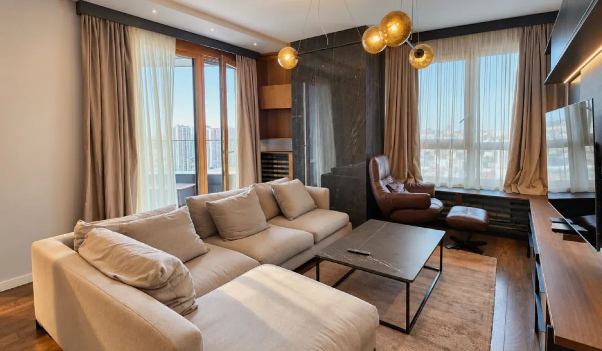Modern living room with a large sectional sofa, coffee table, and television.