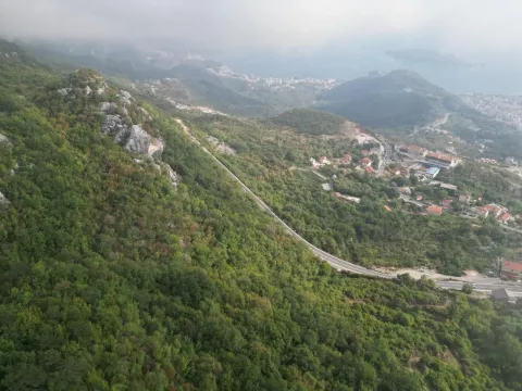 Pogled iz vazduha na planinski pejzaž i naselje u podnožju. - image 4