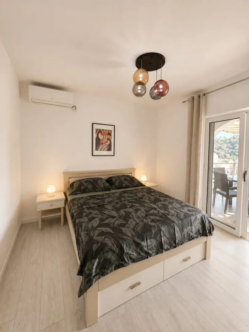Bright and tidy bedroom with a double bed and access to the terrace.