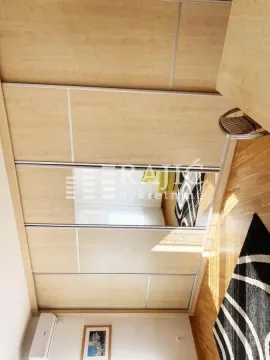 Bedroom with a large fitted wardrobe and wooden floor. - image 8
