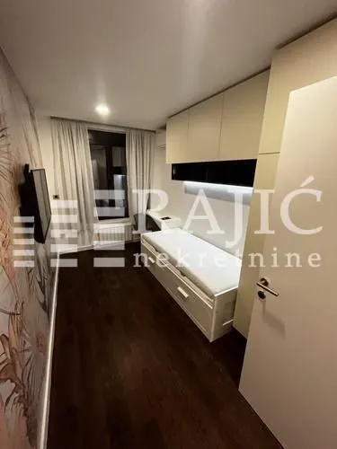 Smaller bedroom with a bed and built-in units.