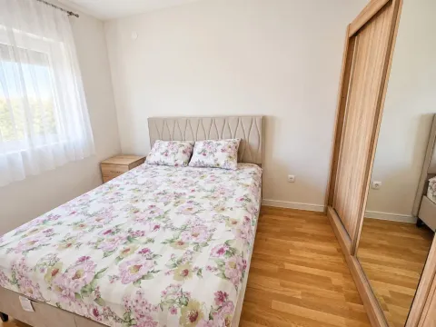 Furnished bedroom with a double bed, wardrobe, and a window. - image 9