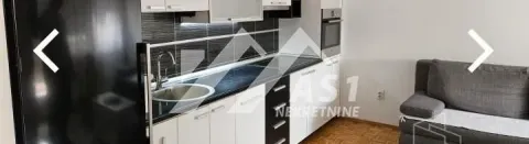 Kitchen equipped with white cabinets and built-in appliances. - image 4