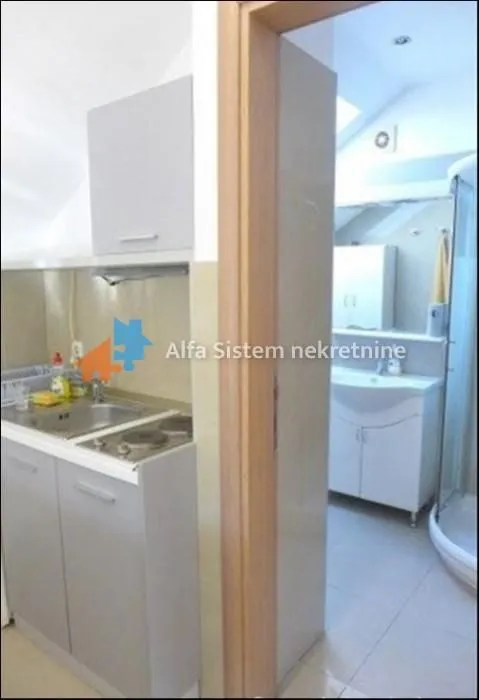 View from the kitchen into the bathroom through an open door.
