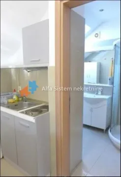 View from the kitchen into the bathroom through an open door. - image 2