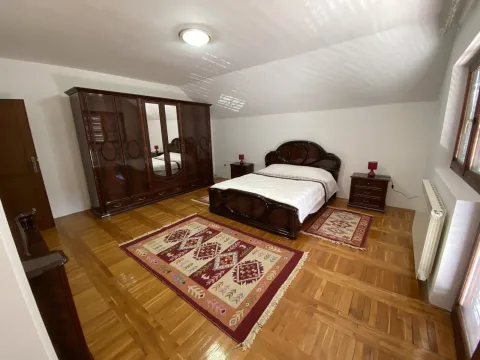 Spacious bedroom with wooden furniture and parquet flooring. - image 6