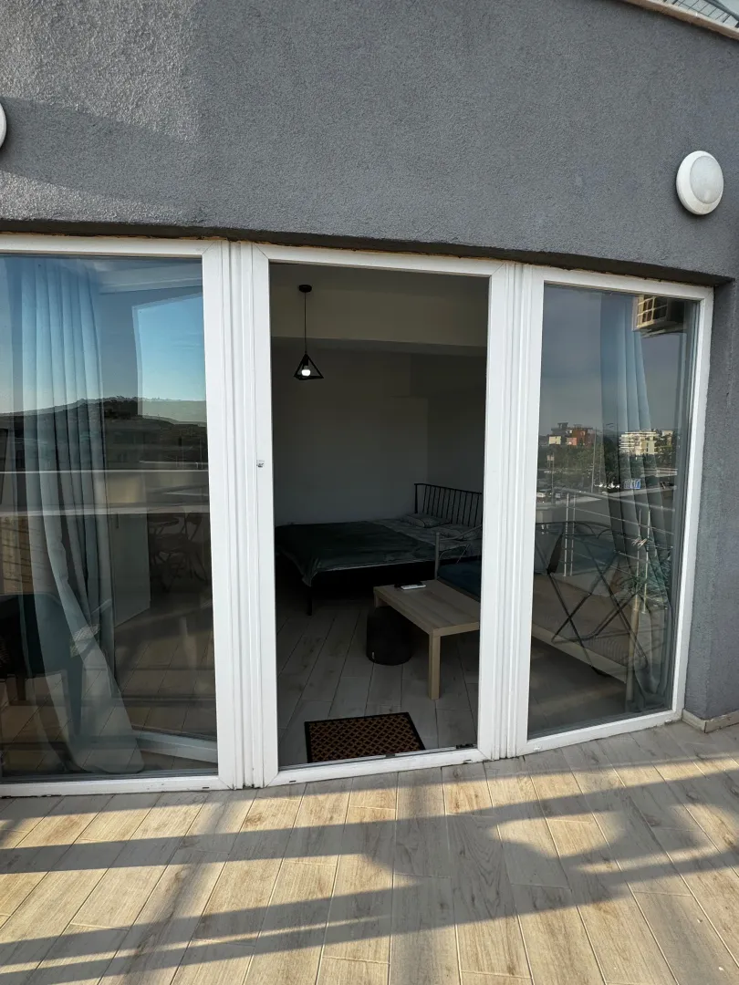 View from the terrace through glass doors towards the interior of the room.