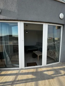 View from the terrace through glass doors towards the interior of the room. - image 9