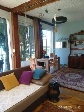 Living room with sofa, dining table and view of the exterior. - image 8