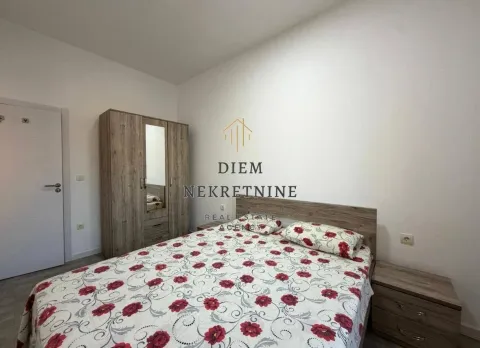 Furnished bedroom with a double bed, wardrobe, and nightstand. - image 4
