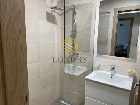Modernly equipped bathroom with a walk-in shower and washbasin. - image 8